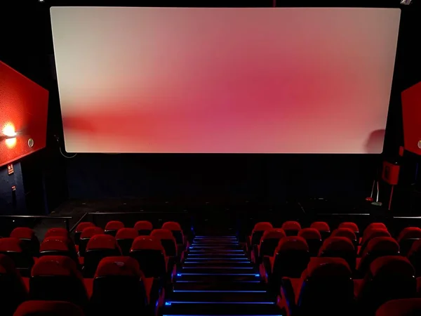 View inside the cinema on the screen and seats before the movie starts. High quality photo