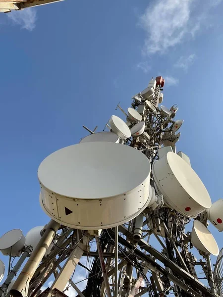 Telecommunication and mobile network infrastructure with two cell site towers side by side, housing antennas and Remote Radio Head, RRH, for greater coverage. High quality photo