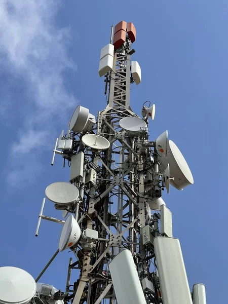 Telecommunication and mobile network infrastructure with two cell site towers side by side, housing antennas and Remote Radio Head, RRH, for greater coverage. High quality photo