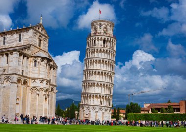 Pisa, ITALY, APRIL 30, 2018 - Tourists vist Campo dei Miracoli square with the iconic Leaning Tower of Pisa