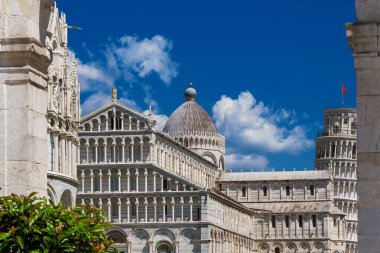 Pisa most famous three landmarks: Leaning Tower, Baptistery and Cathedral in the Square of Miracles, seen through ancient city walls gate