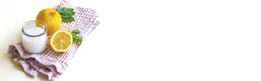 Sol tarafta bir pamuk havlu, üzerinde bir kavanoz krema, limon ve nane yaprakları var. Kavram: kozmetoloji, spa, sağlıklı beslenme, ilaç, vitaminler.