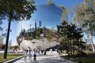 Rotterdam, Netherlands - August 9, 2022 : The new depot building by museum Boijmans van Beuningen for the storage and exposure of 150.000 pieces of art. The skyline of Rotterdam is reflected in the mirrors attached to the building. 