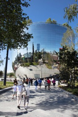 Rotterdam, Netherlands - August 9, 2022 : The new depot building by museum Boijmans van Beuningen for the storage and exposure of 150.000 pieces of art. The skyline of Rotterdam is reflected in the mirrors attached to the building. 