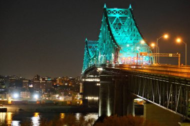 Jacques Cartier Bridge steel truss bridge at night and illuminated