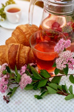 Çilekli meyve suyu ve masada ayçöreği olan limon. Farklı turunçgillerden ev yapımı limonata. Bahçe arka planında ferahlatıcı yaz içeceği.