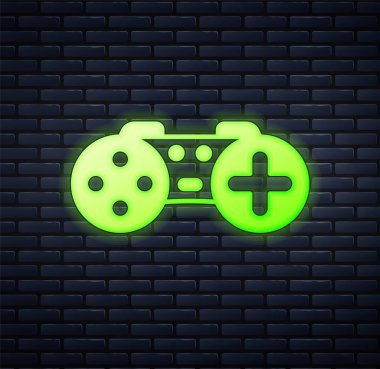 Parlayan neon oyun alanı simgesi tuğla duvar arka planında izole edildi. Oyun kontrolörü. Vektör