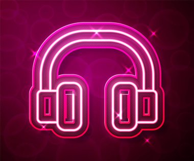 Parlayan neon hattı kulaklık simgesi kırmızı arkaplanda izole edildi. Kulaklıklar. Müzik, hizmet, iletişim ve operatör konsepti. Vektör