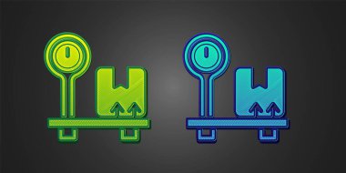 Green and blue Scale with cardboard box icon isolated on black background. Logistic and delivery. Weight of delivery package on a scale. Vector