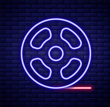 Parlayan neon hattı film makarası ikonu tuğla duvar arka planında izole edildi. Renkli taslak konsepti. Vektör