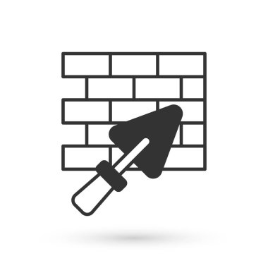 Grey Brick wall with trowel icon isolated on white background. Vector.