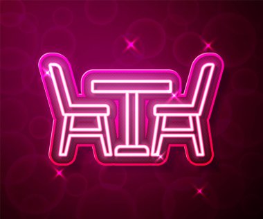 Glowing neon line Wooden table with chair icon isolated on red background. Vector.