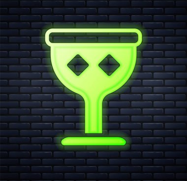 Parlayan neon renkli Ortaçağ kadeh ikonu tuğla duvar arkasında izole edilmiş. Kutsal Kase. Vektör.