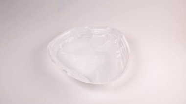 Ekolojik bir sorun. Gezegenin kirliliği plastikle. Çanak çömlek yukarıdan beyaz arka plana düşer. Tabak, cam, çatal, saman beyaz arka plana düşüyor