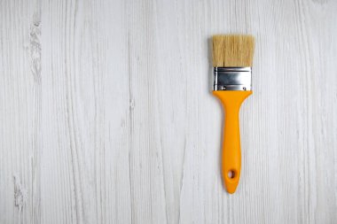 Masadaki boya fırçası, boş yer. Turuncu saplı büyük fırça