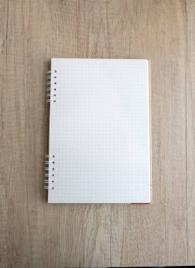 checkered notepad on a wooden table