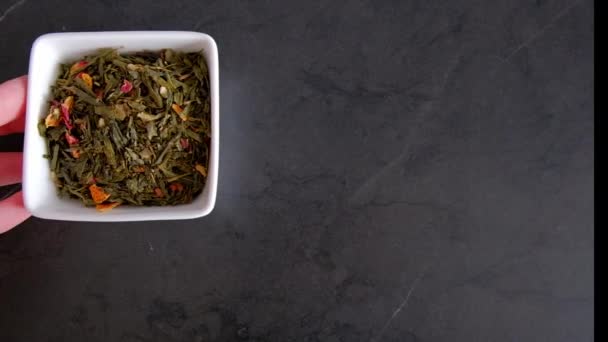 Green Tea Leaves Additives White Plate Black Table Appear Frame — Videoclip de stoc