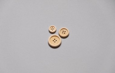 Buttons. three buttons on a gray background. Buttons for clothes. Buttons of various sizes. Family symbol.