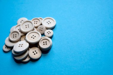 bunch of wooden buttons on a blue background free space. Place for text