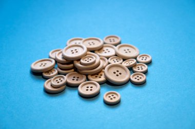 bunch of buttons on a blue background. Sewing. Sewing materials