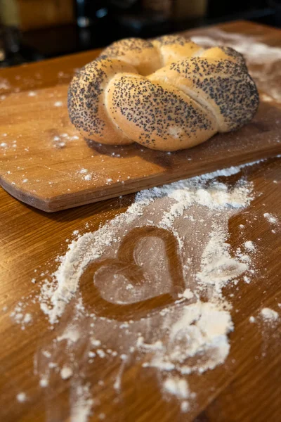 Bun Poppy Seeds Wooden Board Side View Flour Heart Love — Zdjęcie stockowe