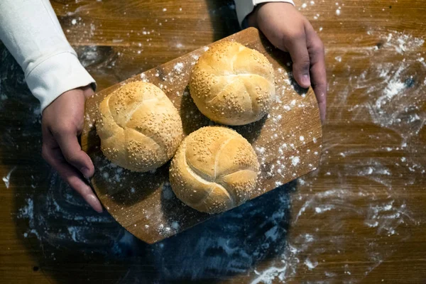 Man Board Buns Sesame Top View Flour Scattered Table Man — Stock Photo, Image