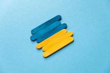 Flag of ukraine on a blue background top and side view. Blue and yellow sticks. Ukraine symbol