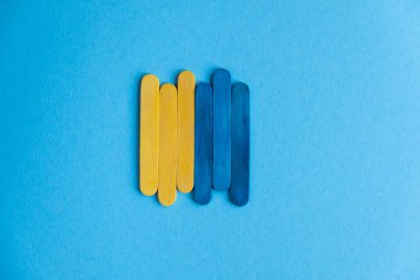 Ukraine flag on a blue background, free space, vertical frame. Place for text.