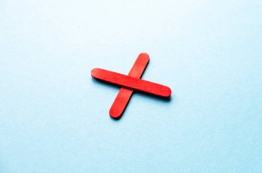 red cross on a blue background. Prohibition sign. Cross made of wooden sticks