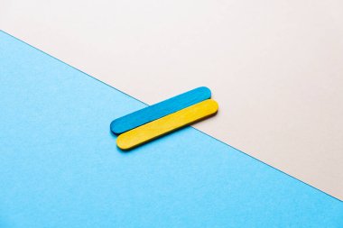 flag of ukraine on a blue and beige background. Flag made of colored wooden sticks