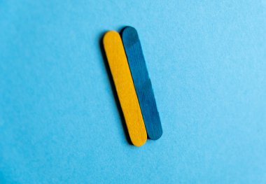 the broken flag of ukraine in the center on a blue background. War in Ukraine