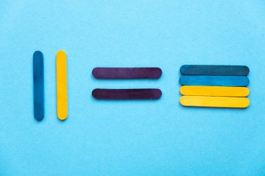 Colored sticks. Nation building. Construction of Ukraine. Help Ukraine. Colored wooden sticks on a blue background