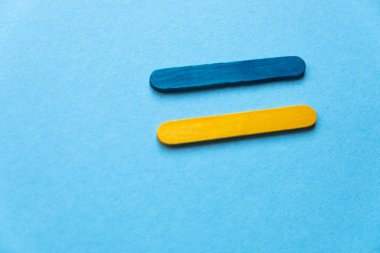 Flag of Ukraine from colored sticks on a blue background