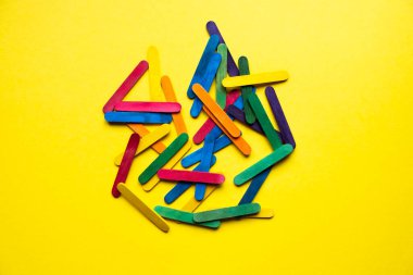 wooden colored sticks on yellow background
