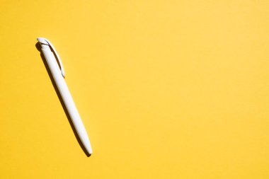 white pen on a yellow background, free space. Place for text