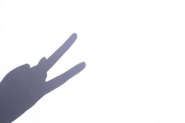 shadow gesture victory on white background, free space