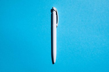 white pen in the center on a blue background