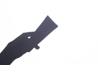 shadow female hand holding a tube of cream. body and face care