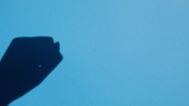 shadow hand points finger to free space. Pay attention