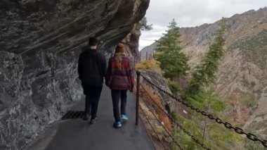 Amerikan Çatal Kanyonu 'ndaki dik uçurum boyunca çift yürüyüş yolu. Timpanogos Mağarası patikasında yürüyüş yapıyorlar..