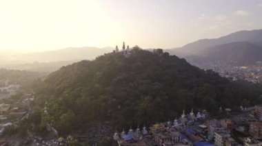 Flying over Kathmandu towards Swayambhunath Stupa to get a closer view of the hill and trees.