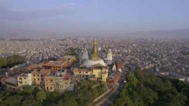 Flying into Swayambhunath Stupa viewing the city of Kathmandu behind.