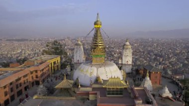 Looking past Swayambhunath Stupa to Kathmandu as Black Kites fly around.
