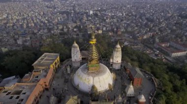 Flying backwards tilting down towards Swayambhunath Stupa in Kathmandu Nepal.