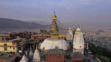 Flying in close to Swayambhunath Stupa viewing the prayer flags blowing in the wind in Kathmandu.