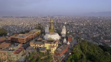 Flying around Swayambhunath Stupa on hilltop in Nepal.