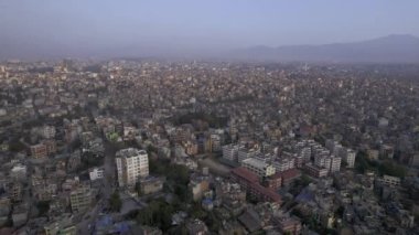 Flying over the city of Kathmandu Nepal viewing the buildings covering the landscape.