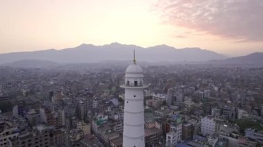 Sunset aerial view flying around the Dharahara Tower looking over Kathmandu Nepal.