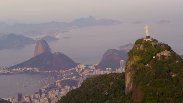 ジャネイロ ブラジル グアナバラ湾を見下ろすコルコバード山と周囲の山の上に立つキリスト Redentor 像の空中追跡映像 — ストック動画