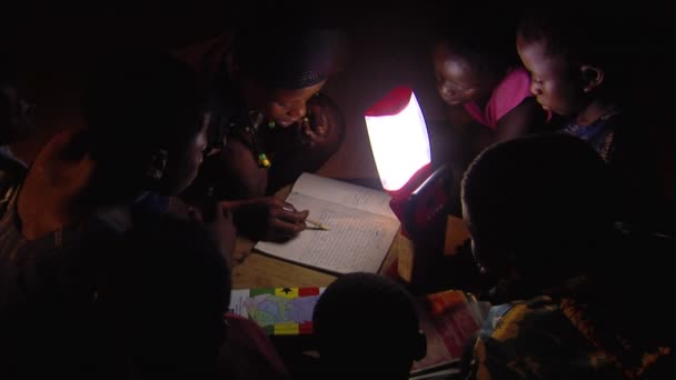 Africa Kenya Circa August 2010 Medium Shot Children Reading Lamp — Stock Video